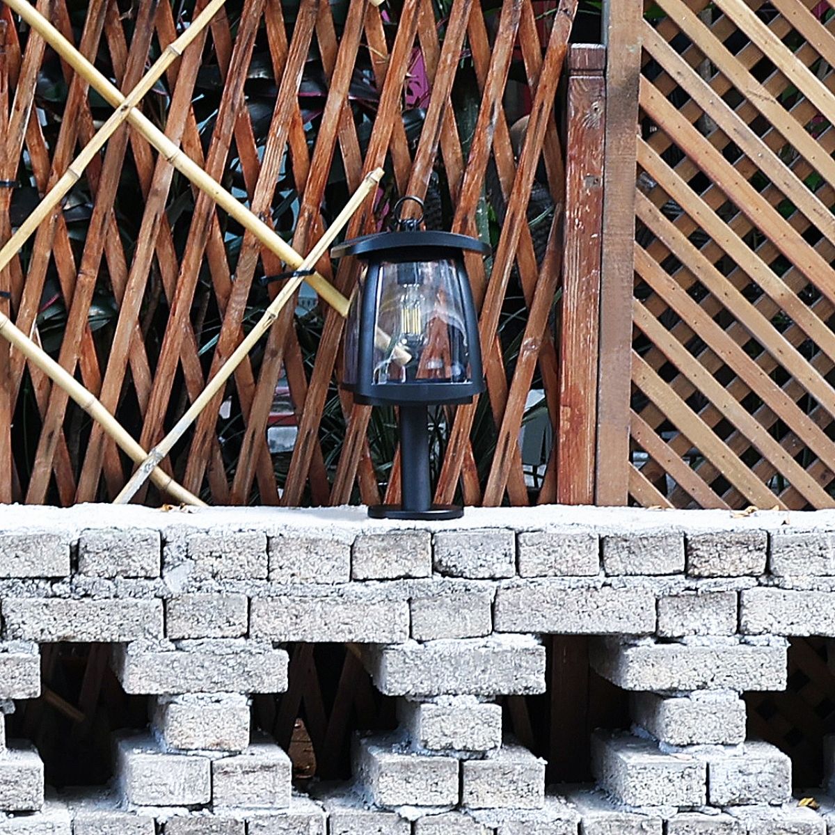 solar LED light installed on the top of a short brick wall