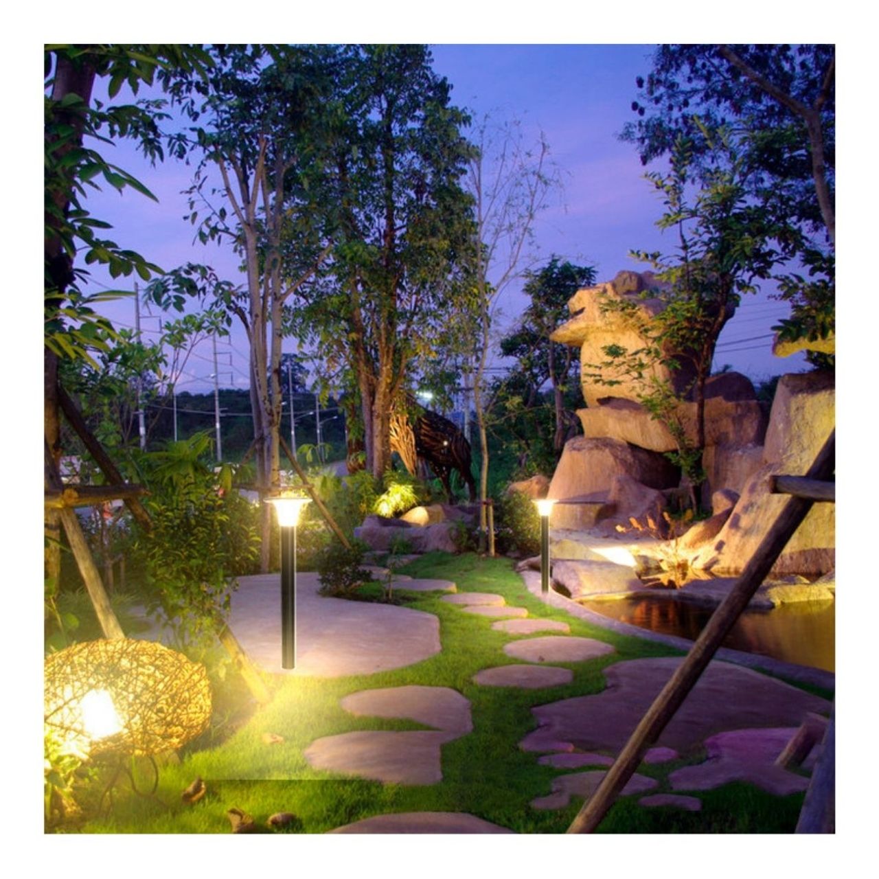 LED Solar Bollard lights lighting a small tree-filled area